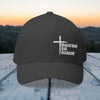 Man of God Dad Husband Embroidered Flexfit Hat against a scenic background, celebrating faith and family.
