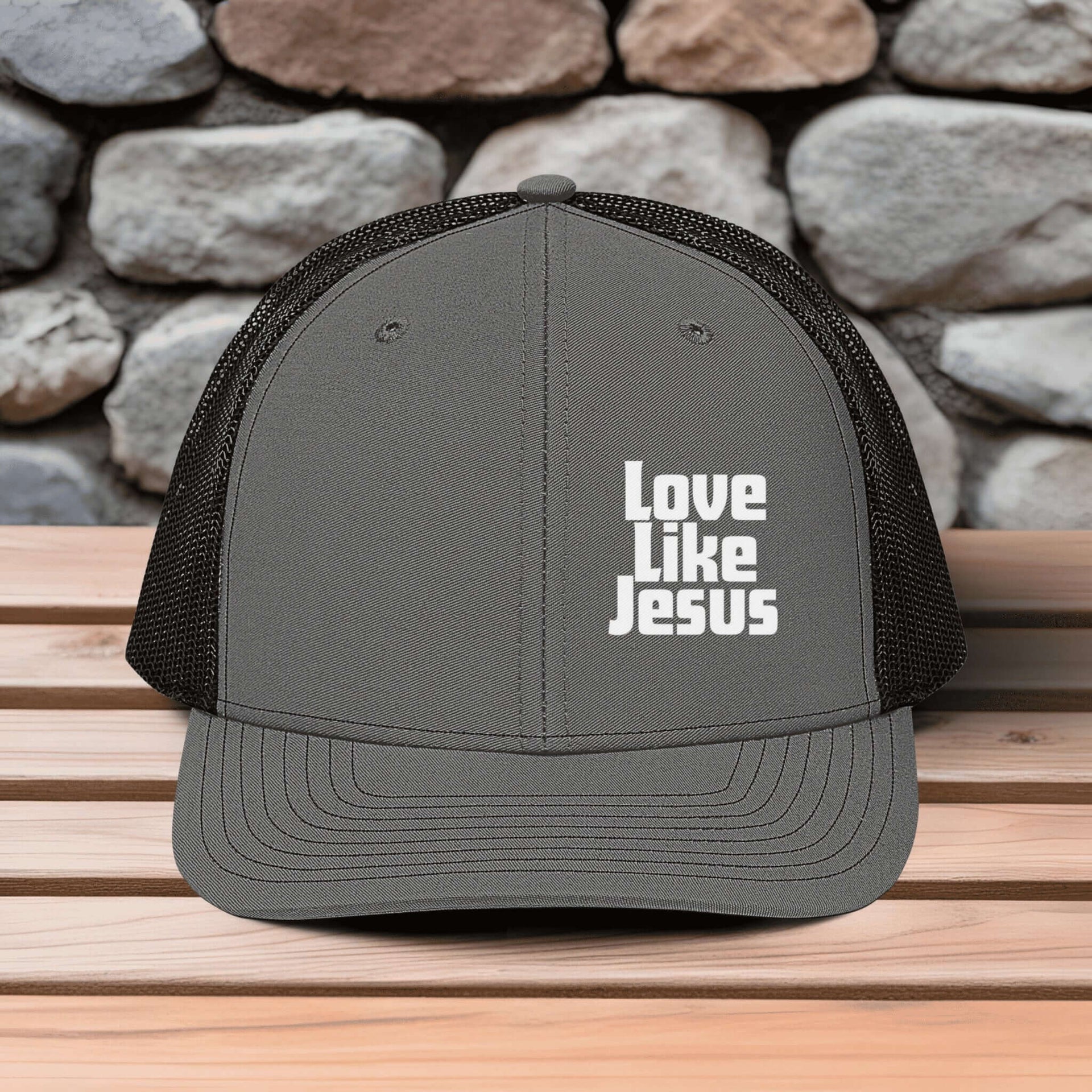 Love Like Jesus snapback hat featuring bold white embroidery on a gray trucker hat.