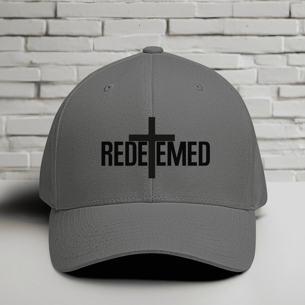 Redeemed Embroidered Flexfit Hat with a cross design, representing faith and style.