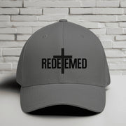 Redeemed Embroidered Flexfit Hat with a cross design, representing faith and style.