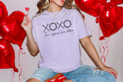 XOXO The Original Love Letters Tee Crown of Thorns Shirt worn by a woman surrounded by heart-shaped balloons.