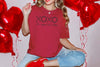 XOXO The Original Love Letters Tee Crown of Thorns Shirt worn with red heart balloons in background, perfect for Valentine's Day.