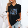 Woman wearing Jesus Loves You & Me T-shirt with John 15:13 design, styled in a relaxed and casual outdoor setting.
