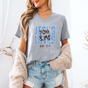 Model wearing a Jesus Loves You & Me T-shirt featuring John 15:13, in a casual setting with a cozy cardigan.