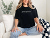 Jesus Loves Me Unisex T-shirt displayed on a woman sitting comfortably in casual attire, showcasing faith graphic design.