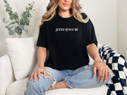Jesus Loves Me Unisex T-shirt displayed on a woman sitting comfortably in casual attire, showcasing faith graphic design.
