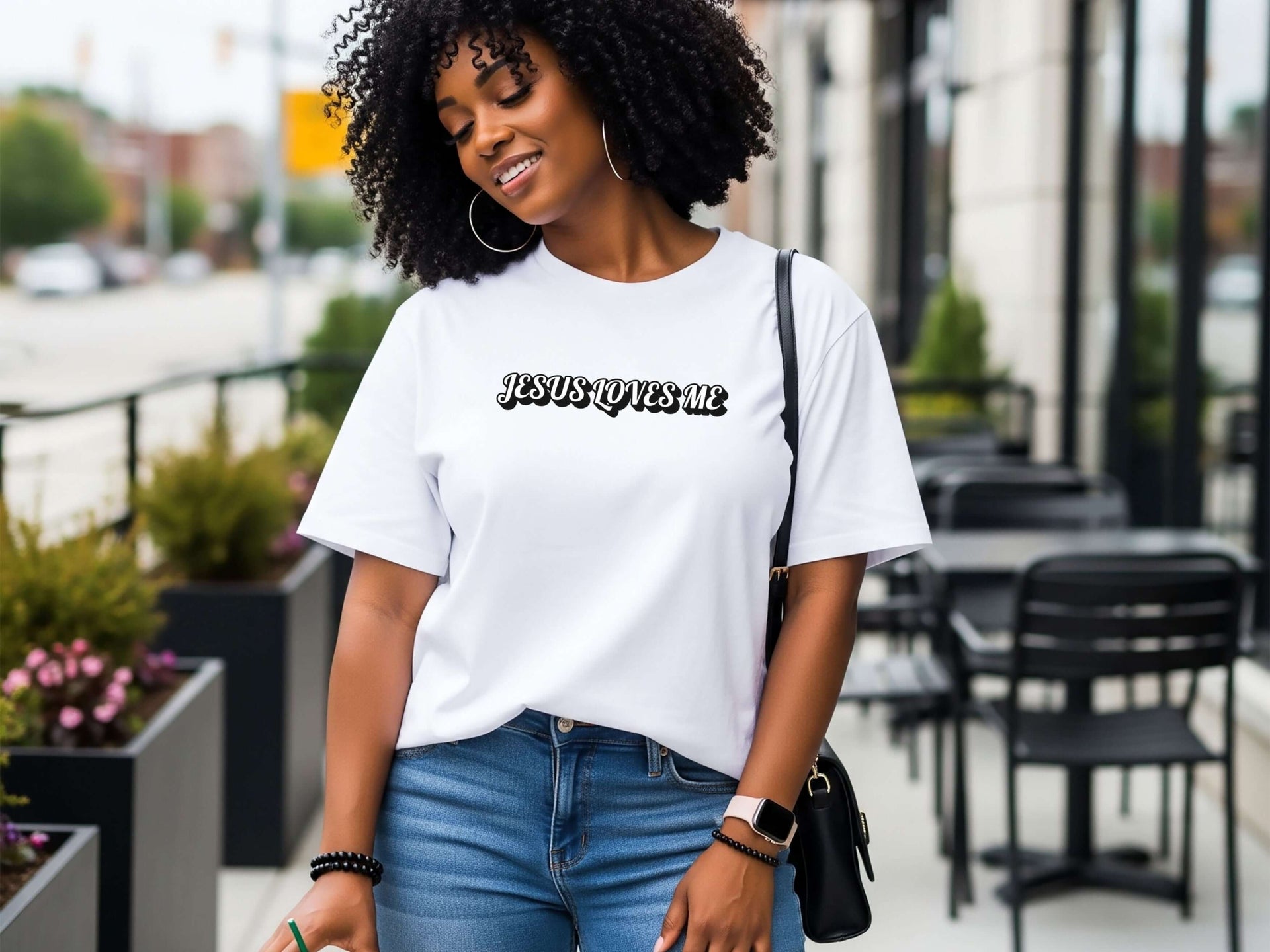 Jesus Loves Me Unisex T-shirt worn by a woman outdoors, showcasing faith graphic design and relaxed fit.