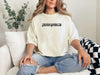 Person wearing a Jesus Loves Me Unisex T-shirt, sitting casually with relaxed fit and stylish comfort.