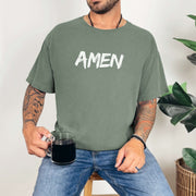 Amen Brush Stroke Text T-Shirt worn by man holding coffee, featuring bold 'AMEN' text in a minimalist design.