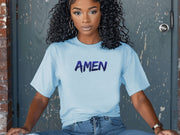 Amen Brush Stroke Unisex T-shirt worn by a model with curly hair, sitting against a rustic background.
