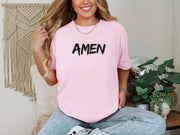 Amen Brush Stroke Unisex T-shirt worn by a model, featuring a pink color with bold 'AMEN' text.