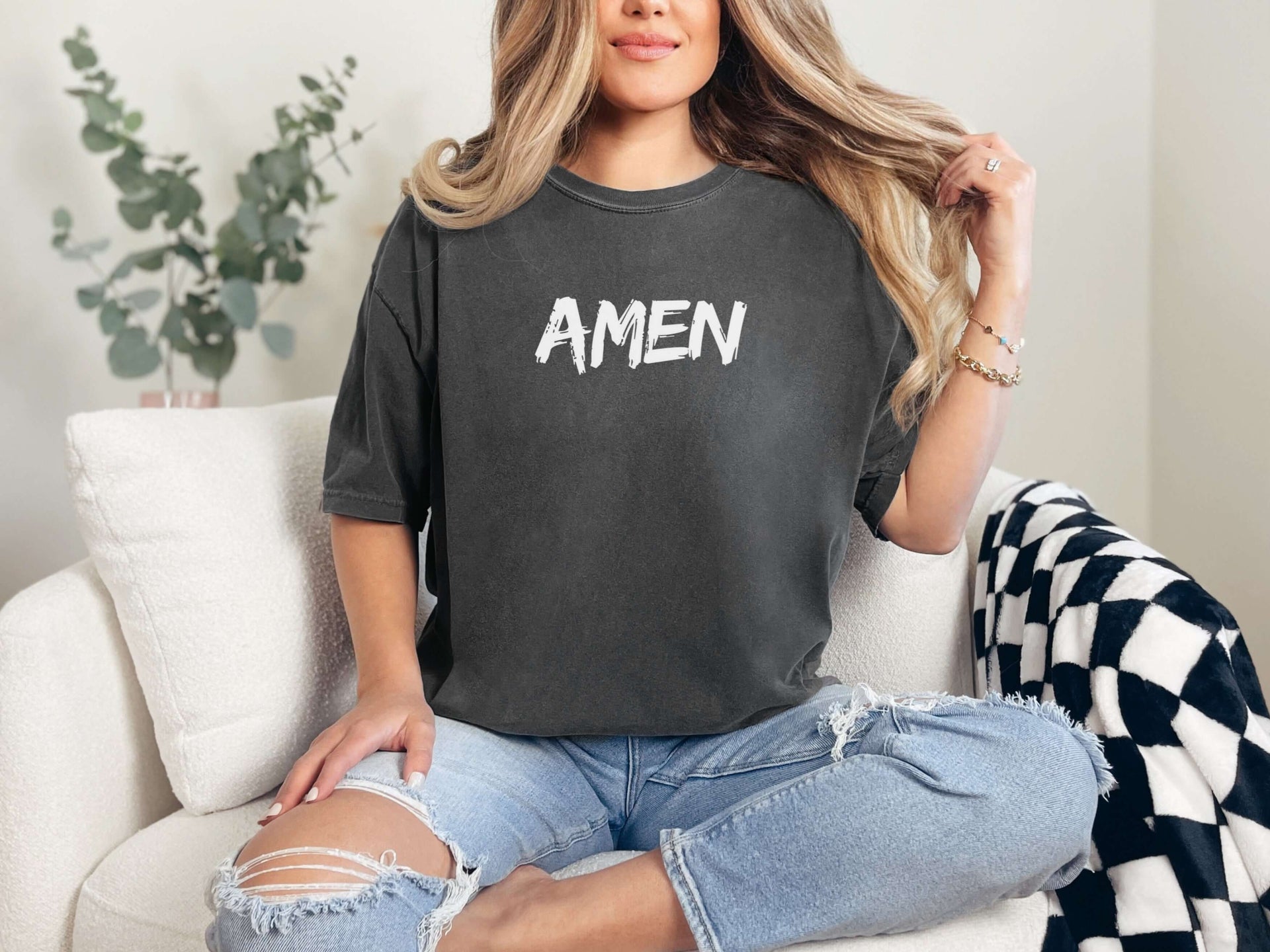 Amen Brush Stroke Unisex T-shirt in dark gray with bold print worn casually in a relaxed setting.