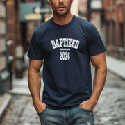 Person wearing a Baptized 2026 T-Shirt in a city street setting.