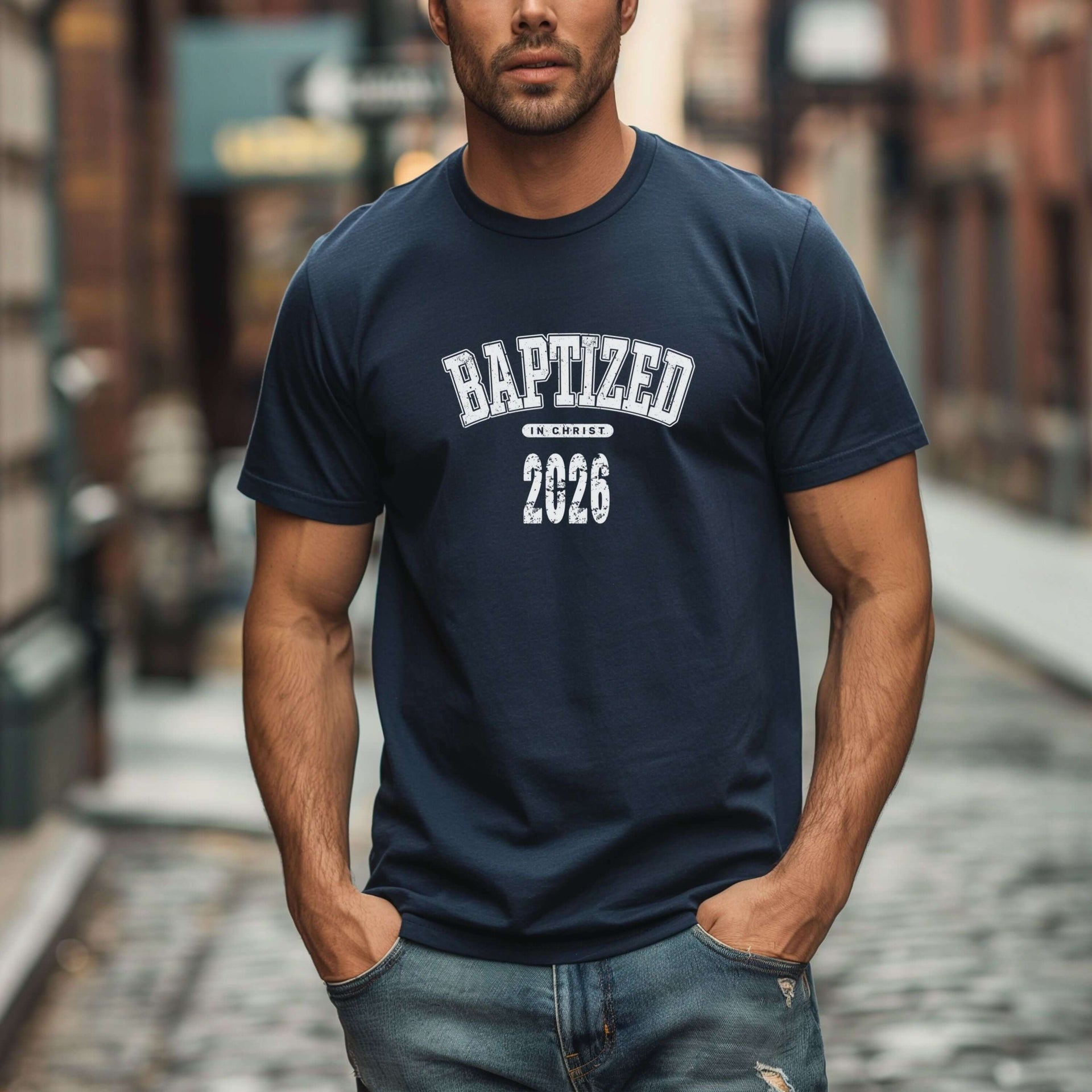 Person wearing a Baptized 2026 T-Shirt in a city street setting.