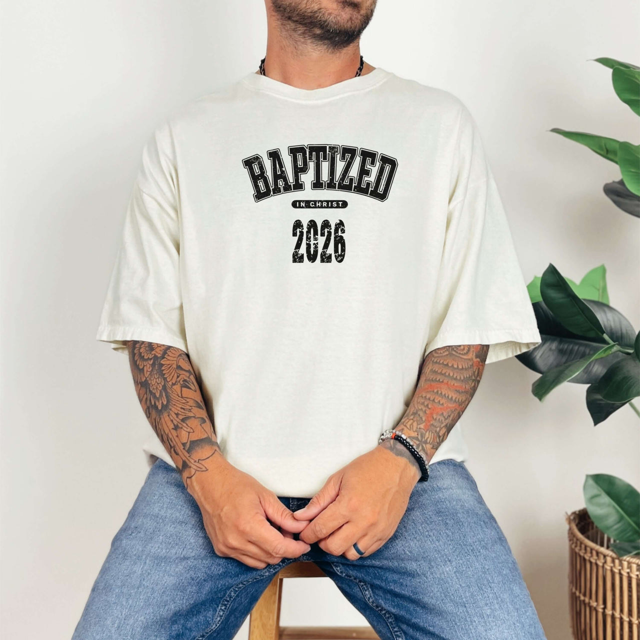Person wearing Baptized 2026 T-Shirt, showcasing bold lettering and relaxed fit against a light background.