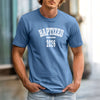 A man wearing a Baptized 2026 T-Shirt in blue, showcasing bold text celebrating baptism.