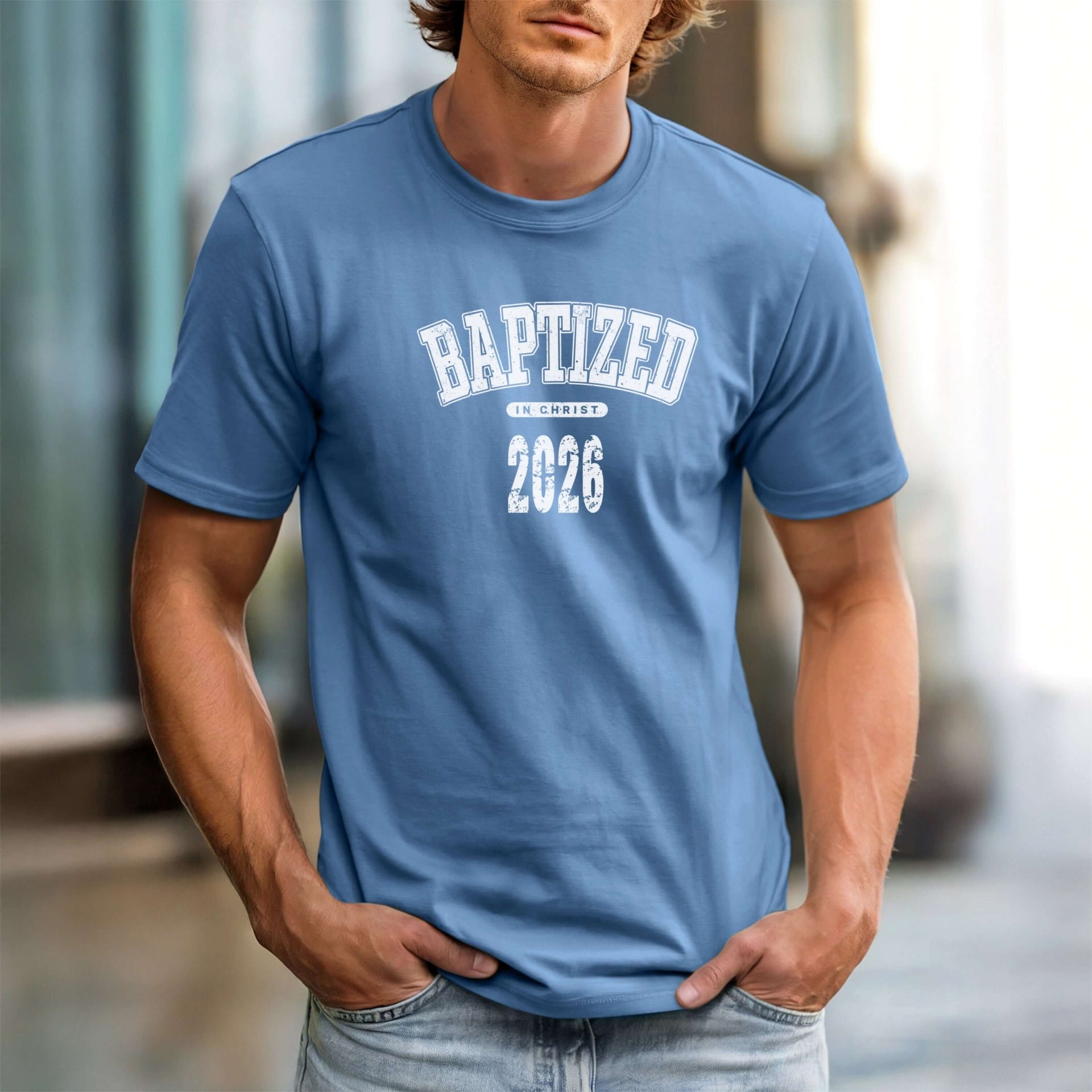 A man wearing a Baptized 2026 T-Shirt in blue, showcasing bold text celebrating baptism.