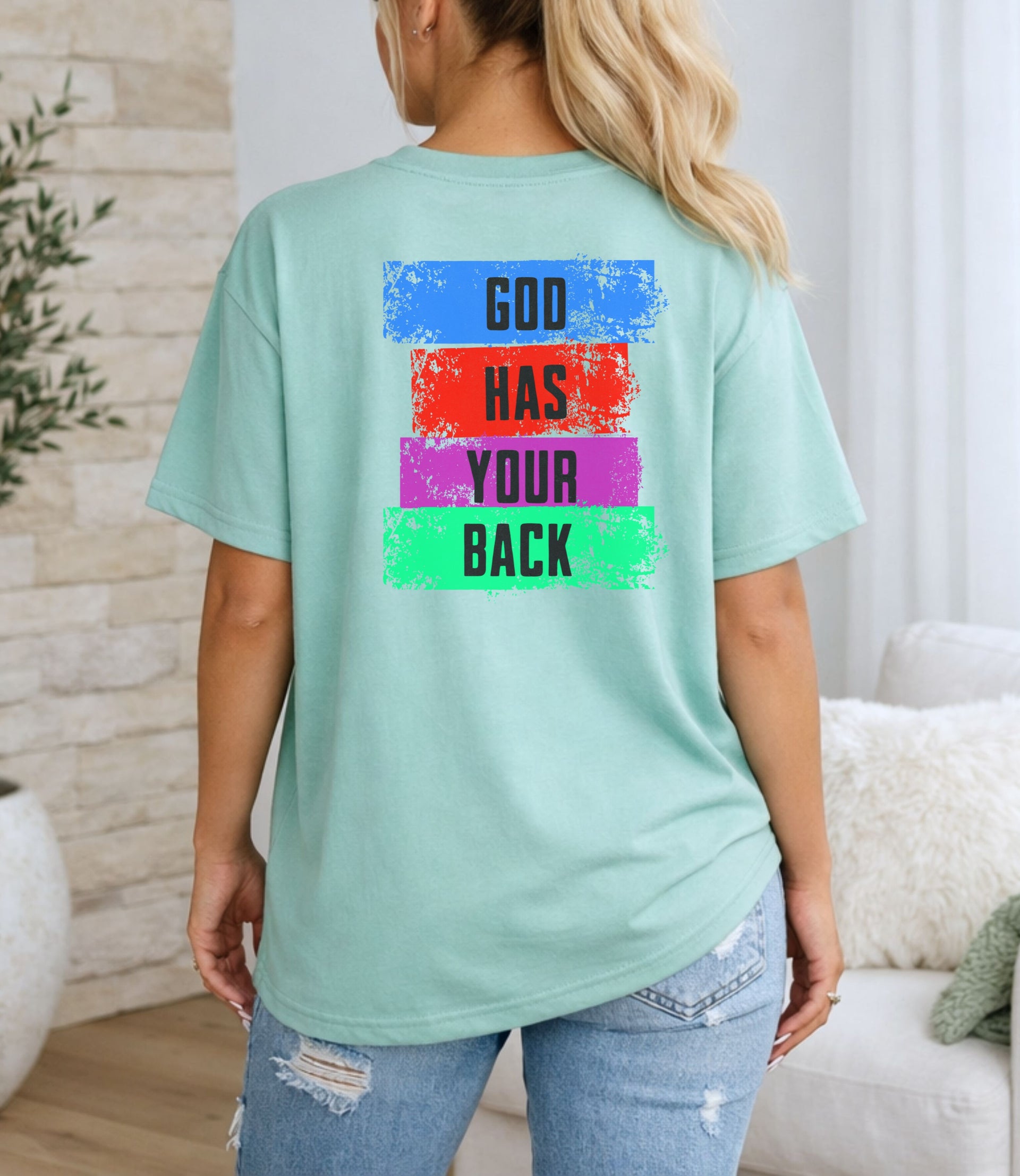 Back view of God Has Your Back T-Shirt featuring a color block design in vibrant colors.
