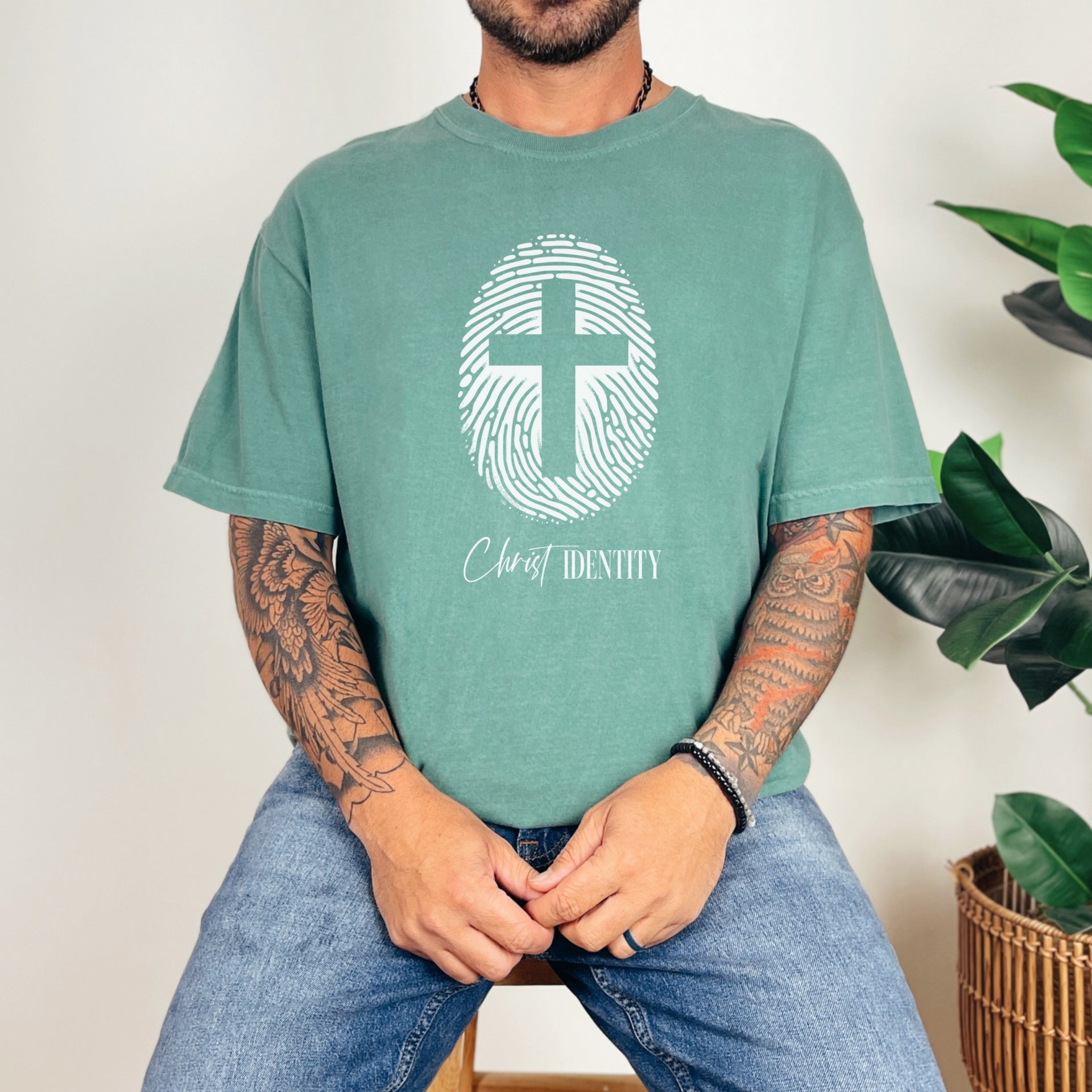 Cross Fingerprint Identity Unisex T-shirt featuring a bold fingerprint cross graphic on a light green t-shirt.