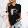 Model wearing She Laughs Without Fear Of The Future V Neck Tee with floral design in a stylish setting.