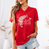 Model wearing the She Laughs Without Fear Of The Future V Neck Tee in red with floral design and Proverbs 31:25.
