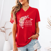 Model wearing the She Laughs Without Fear Of The Future V Neck Tee in red with floral design and Proverbs 31:25.