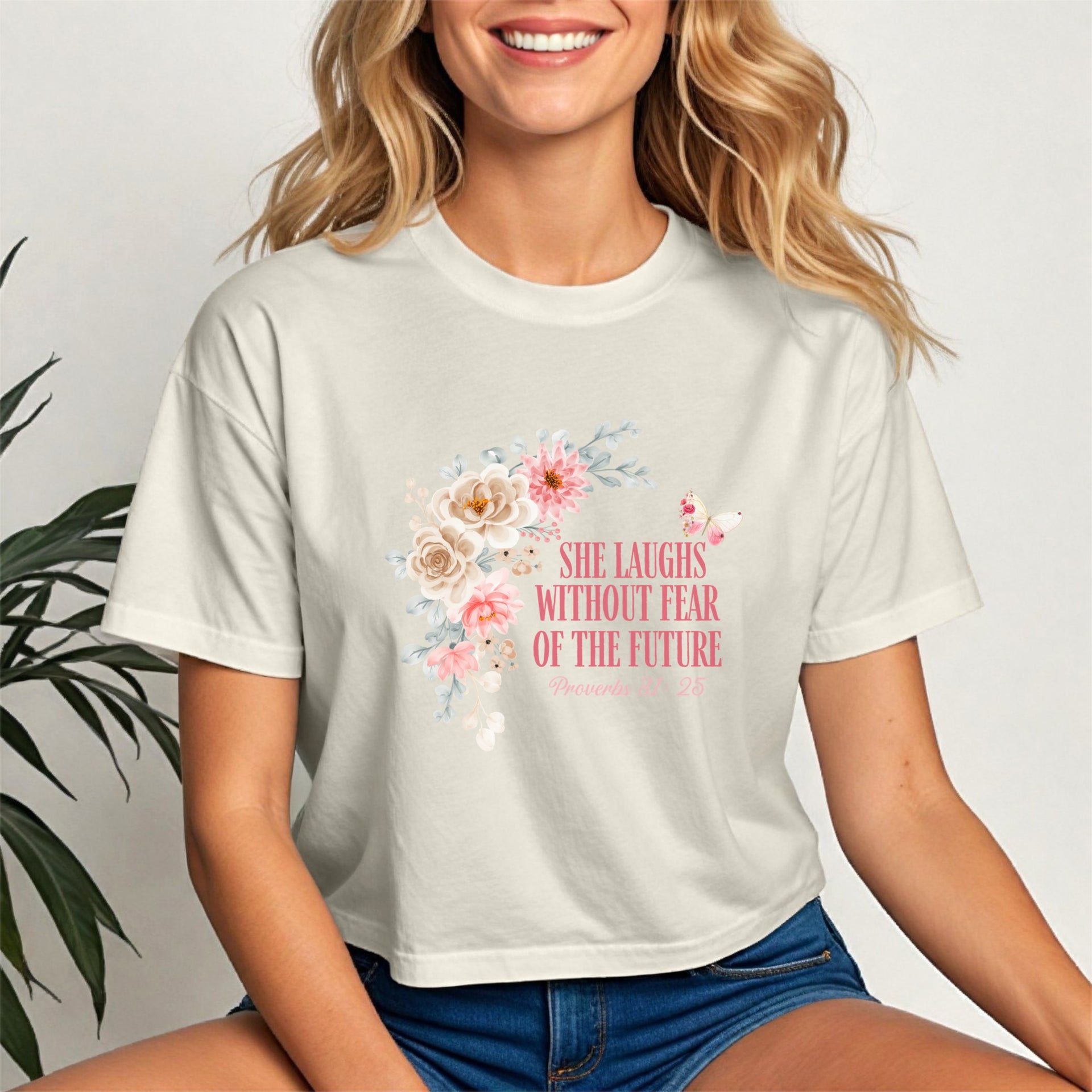 She Laughs Without Fear Of The Future Crop Tee featuring a floral design and uplifting message.