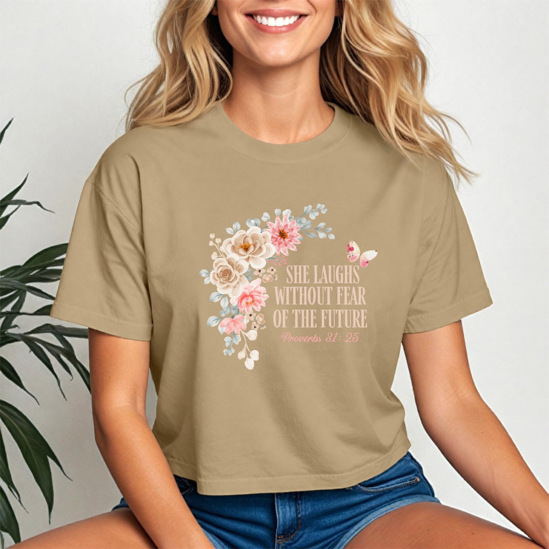 She Laughs Without Fear Of The Future Crop Tee featuring floral design on a model, empowering and stylish.