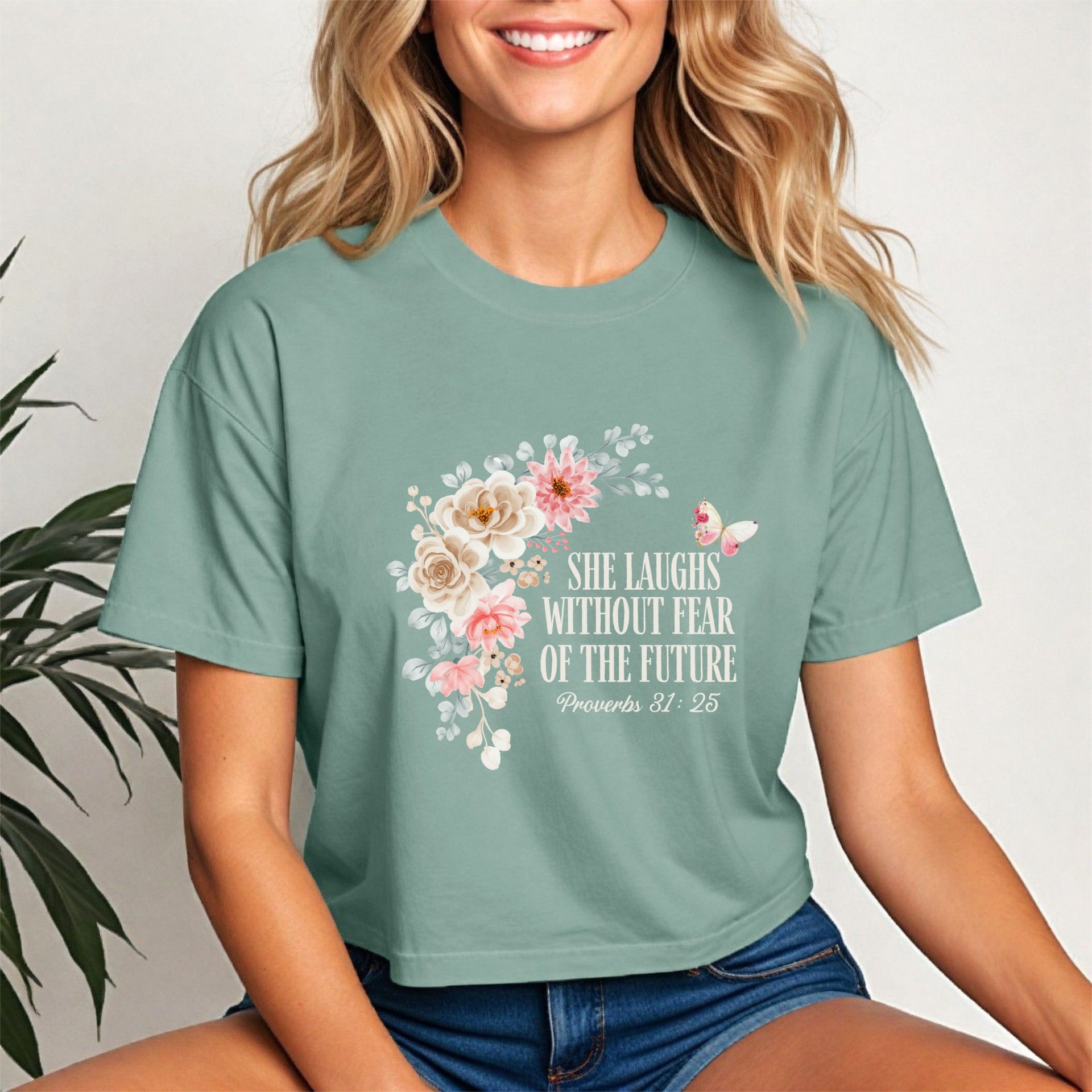 She Laughs Without Fear Of The Future Crop Tee with floral design, embodying strength and confidence.