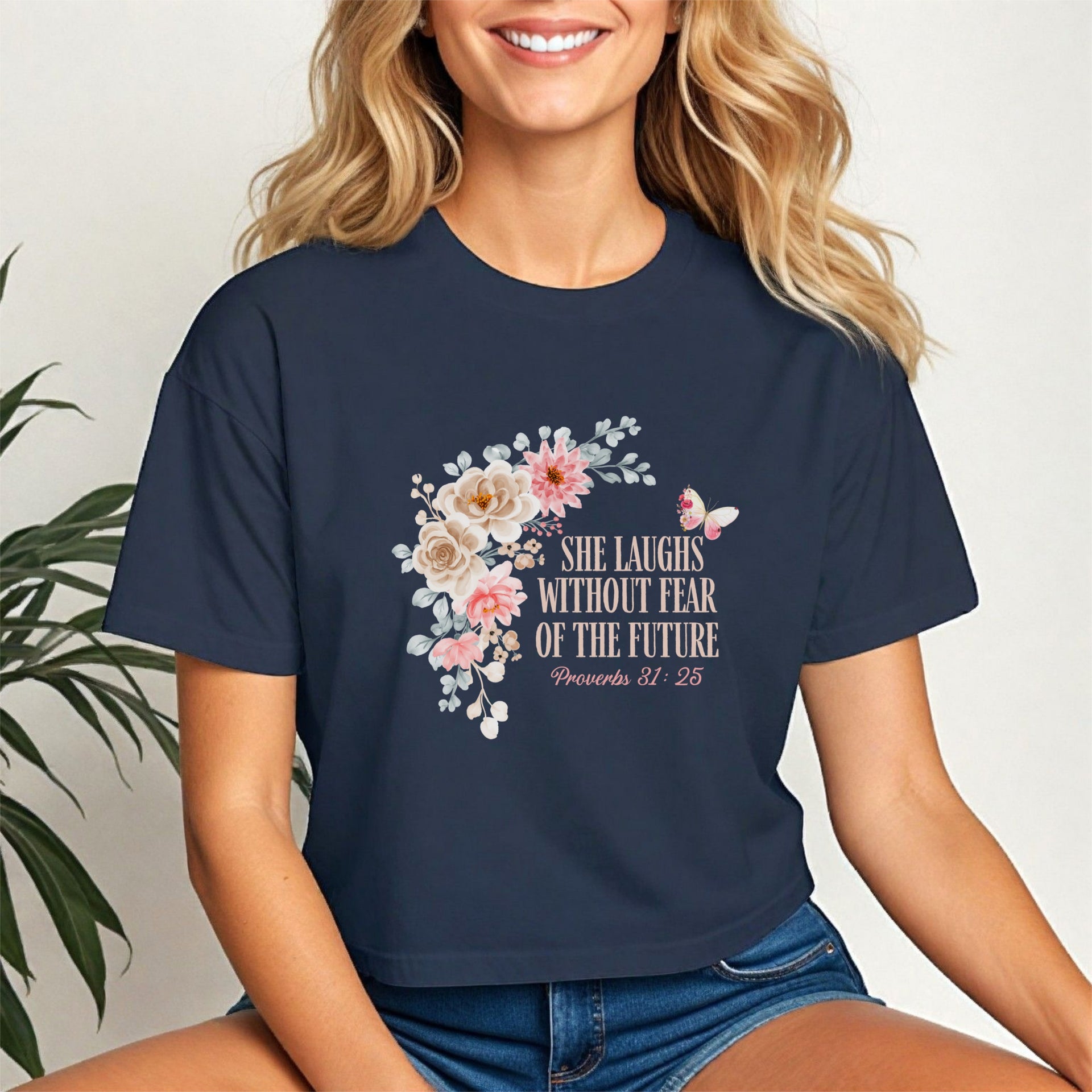 Model wearing She Laughs Without Fear Of The Future Crop Tee with floral design and Proverbs 31:25.