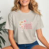 She Laughs Without Fear Of The Future Crop Tee with floral design worn by a smiling woman.
