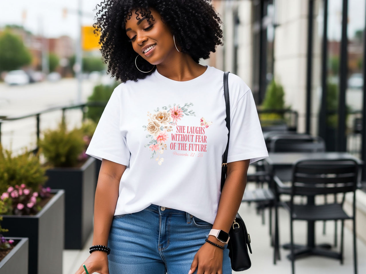 Woman wearing She Laughs Without Fear Of The Future Floral T Shirt with floral design, showcasing confidence and style.