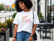 Woman wearing She Laughs Without Fear Of The Future Floral T Shirt with floral design, showcasing confidence and style.