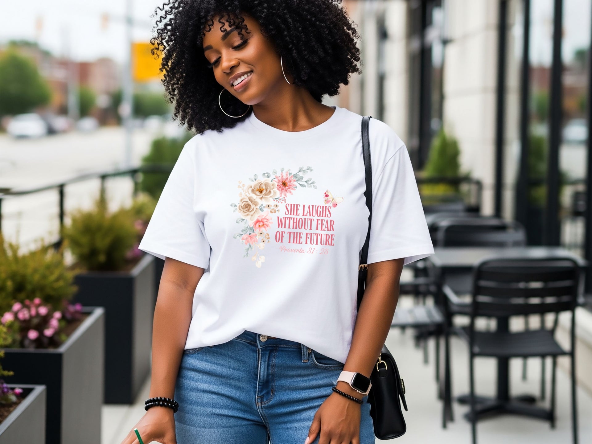 Woman wearing She Laughs Without Fear Of The Future Floral T Shirt with floral design, showcasing confidence and style.
