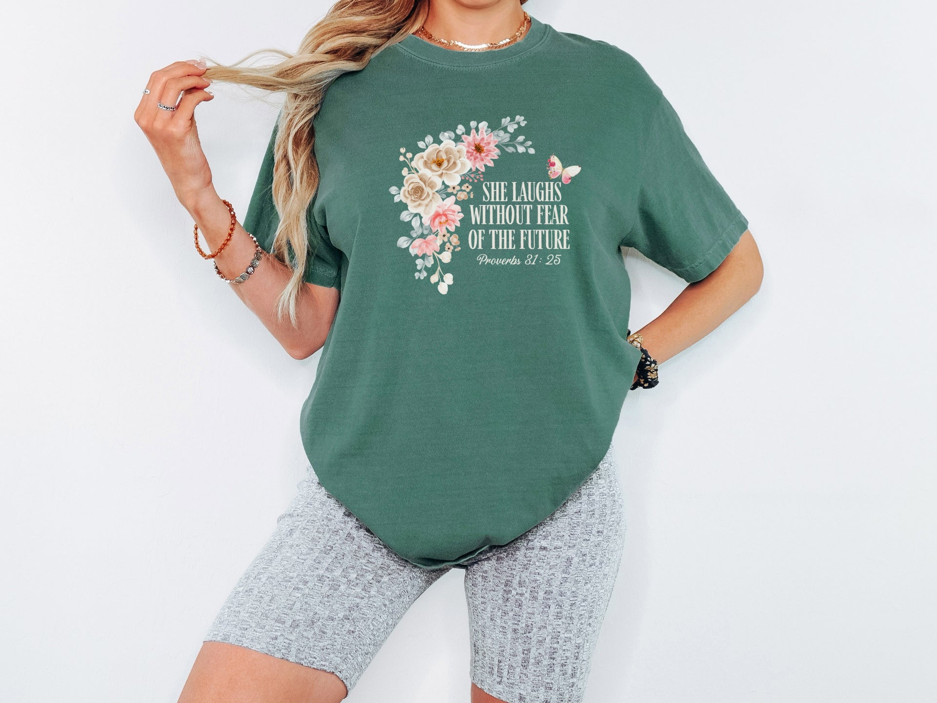 She Laughs Without Fear Of The Future Floral T Shirt worn by a model, showcasing a floral design and inspirational message.