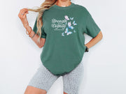 Strength And Dignity Proverbs 31 25 Butterfly T Shirt worn by a model with butterfly graphic on a green tee.