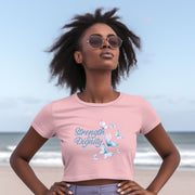 Strength And Dignity Proverbs 31 25 Butterfly Crop Tee on a model at the beach, showcasing confidence and grace.