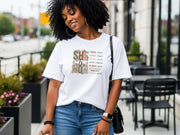 She Is Mom Floral Typography T Shirt worn by a smiling woman in casual setting with floral design.
