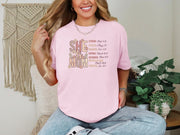 She Is Mom Floral Typography T Shirt in pink, showcasing floral design and positive affirmations for moms.