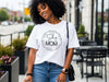 She Is Mom Circle Script T Shirt worn by a smiling woman outdoors in a casual setting.