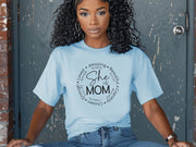 She Is Mom Circle Script T Shirt worn by a woman with curly hair, showcasing a circular script design celebrating motherhood.