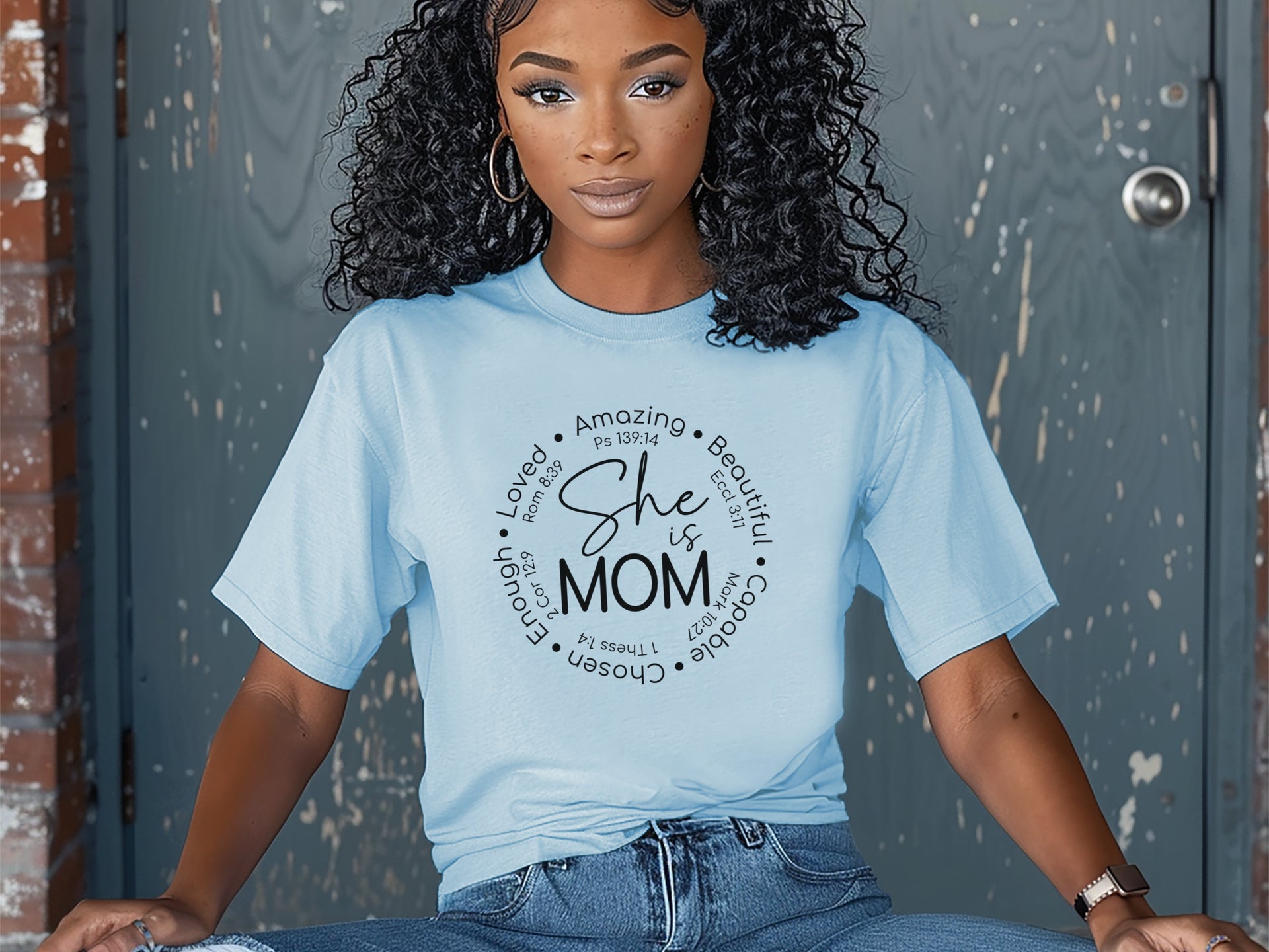 She Is Mom Circle Script T Shirt worn by a woman with curly hair, showcasing a circular script design celebrating motherhood.