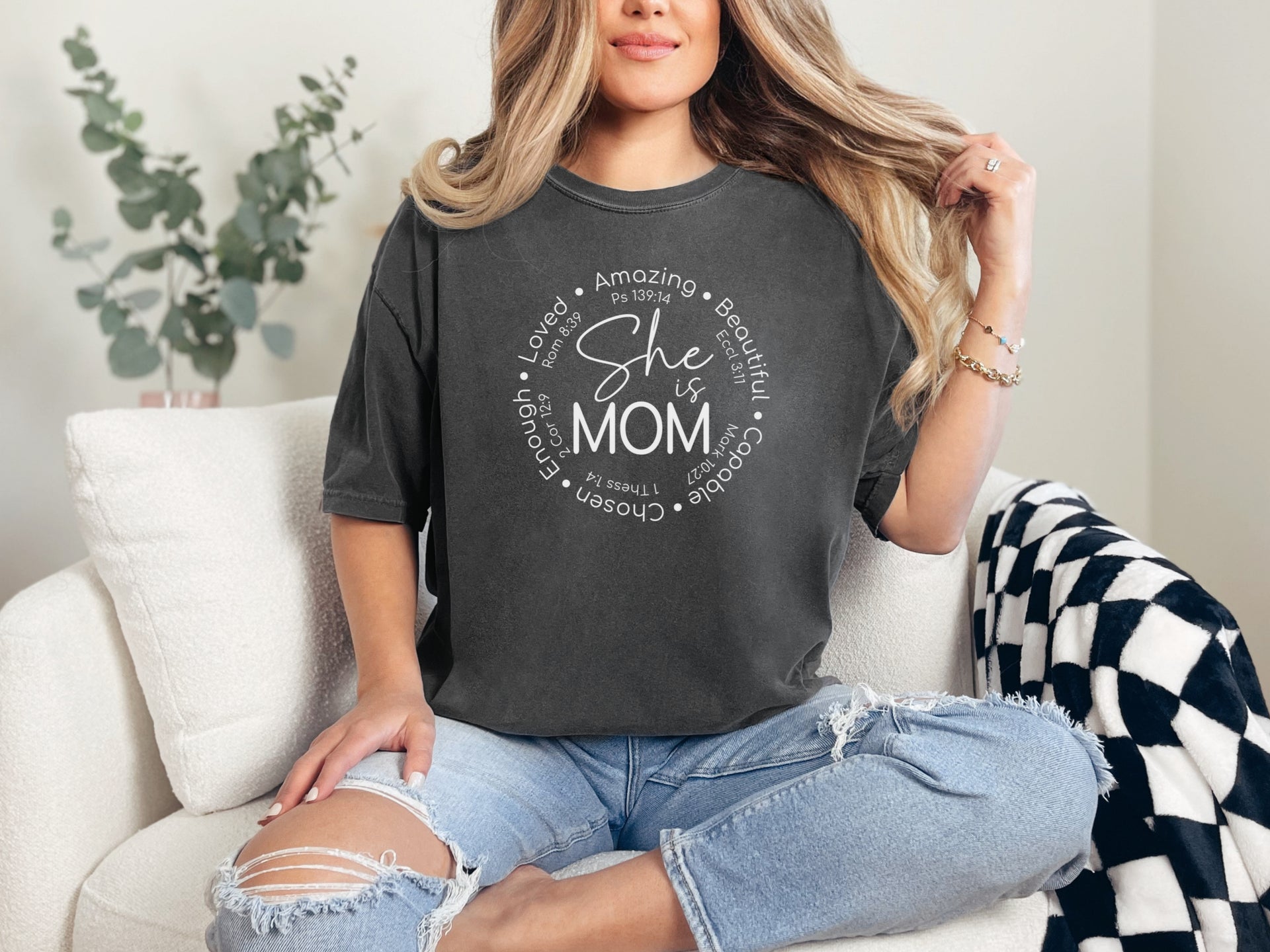 Woman wearing She Is Mom Circle Script T Shirt, showcasing motherhood with circular script design.
