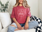 She Is Mom Circle Script T Shirt displayed on a model, showcasing its soft fabric and circular script design.