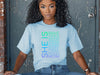 Woman wearing SHE IS vertical affirmation mom T-Shirt with positive affirmations for mothers.