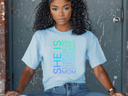 Woman wearing SHE IS vertical affirmation mom T-Shirt with positive affirmations for mothers.