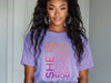 SHE IS vertical affirmation mom T-Shirt featuring uplifting typography in vibrant colors on a model.