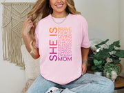 SHE IS vertical affirmation mom T-Shirt design with positive affirmations, worn by a smiling woman, showing comfort and style.