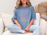 SHE IS vertical affirmation mom T-Shirt worn by a woman, showcasing vibrant positive affirmations for moms.