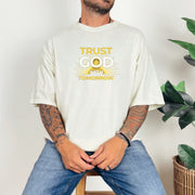 Trust God With Tomorrow T-Shirt displayed on a model, conveying a message of faith and hope, featuring a light color and relaxed fit.